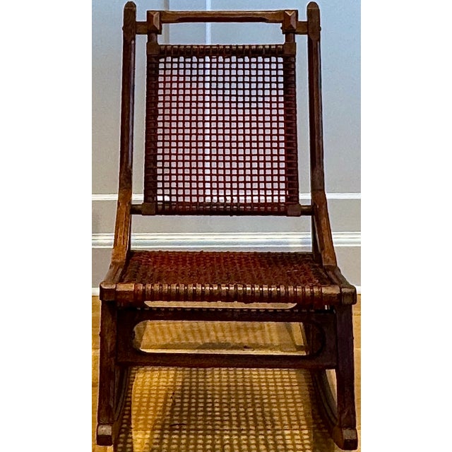 Stamped “Hunzinger” and “Pat. April 18, 1876,” this American Aesthetic Movement walnut rocker features Hunzinger’s...