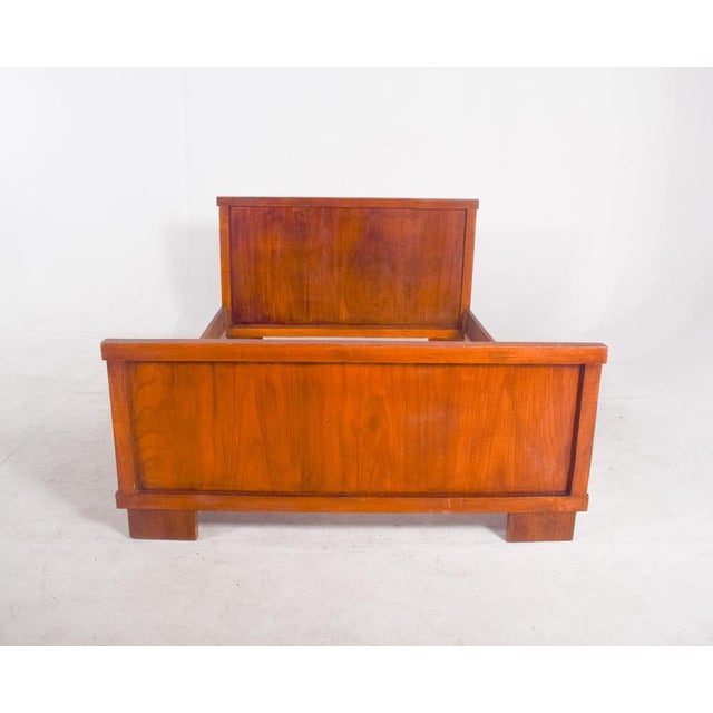 This is a Portuguese wooden bed frame from the 1950s, showcasing the simplicity and elegance of mid-century design....