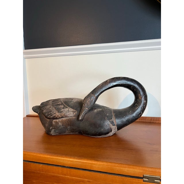 A sculptural hand-carved durastone swan by Austin Productions, dating to the 1970s. Executed with an elegantly curved...