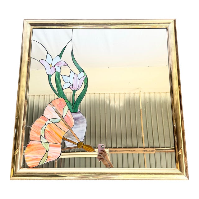 This striking postmodern wall mirror features a hand-crafted stained glass lily motif set against a luminous mirrored...