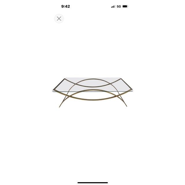 Italian Modern Brass Cocktail Table. Offered is a stunning shapely mid-century Italian brass and glass cocktail table or...