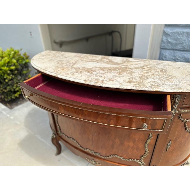 Bring timeless French elegance to your space with this exquisite Louis XV-style sideboard. Crafted with a demilune (half-...