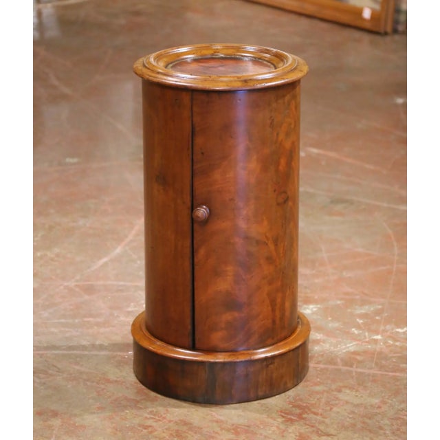 With its distinctive cylindrical silhouette and warm walnut patina, this antique Louis Philippe somno table combines...