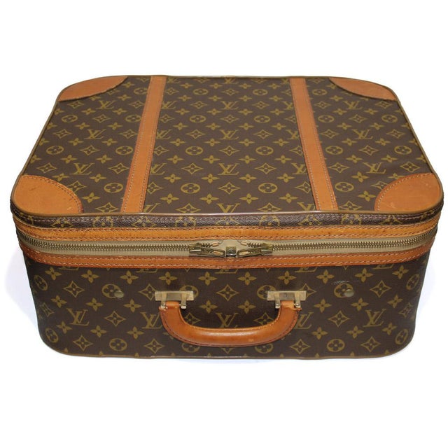 Original Vintage Rigid Louis Vuitton suitcase made of monogram canvas with natural cowhide finishes and golden brass...