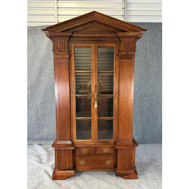This vintage Hickory Chair William E. Poole china cabinet is crafted from rich mahogany and features a striking...