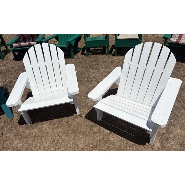 Late 20thc original hand crafted & white painted pair of Adirondack porch or lawn chairs.These hand crafted chairs have...