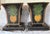 A pair of vintage tole planters with hand-painted pineapple motif on the front and back panels. Scrolled lion head handles...