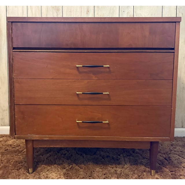 Elevate your space with this timeless mid-century modern gem—a compact 3-drawer lowboy dresser that embodies the era's...