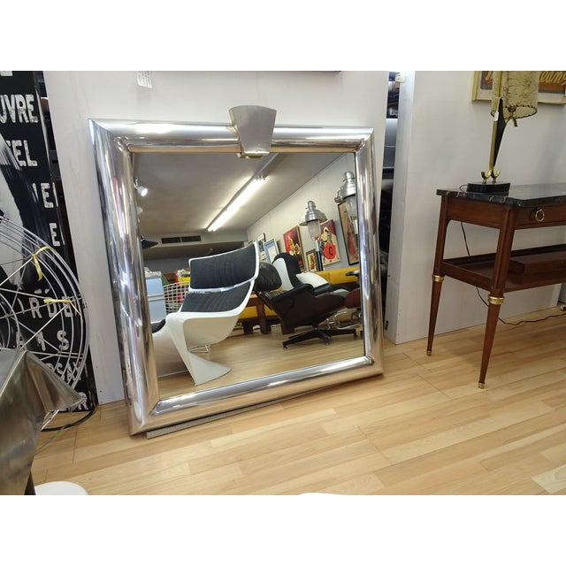 Square Mirror in wide bullnose, rounded, polished, aluminum frame with shield insert on top edge. Corners are fused and...