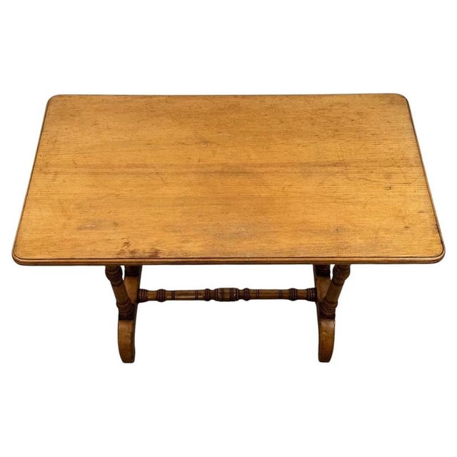 A handsome 19th-century English side table, finely crafted from oak and distinguished by its elegant proportions,...