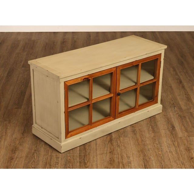 Pier 1 Imports Media Or Storage Cabinet Featuring A Painted Cream Case With Contrasting Wood Framed Glass Doors. Cabinet...