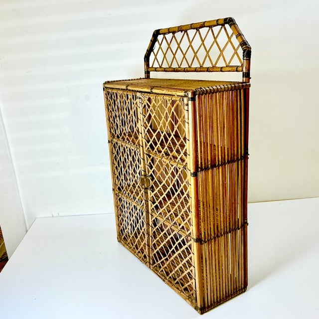 Chippendale criss cross design is classic and always in style. This wall-mounted 3-shelf wicker cabinet is lovely with a...