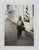 1950's vernacular snapshot photograph of cityscape with working man walking by a barber shop and barber pole. Unframed.