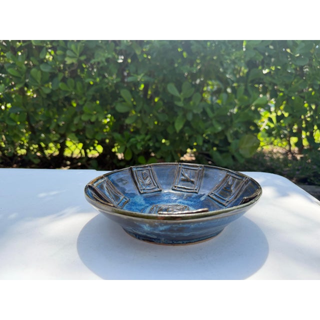 A beautifully crafted vintage studio pottery bowl featuring a rich blue glaze with striking tonal variation throughout....