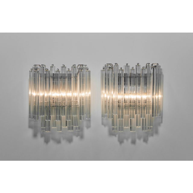 Pair of wall sconces by Camer, Italy, 1970s. Featuring clear Venini Murano glass prisms , these sculptural lights are...