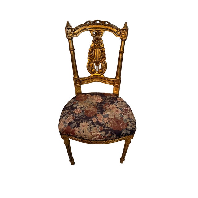 This French antique gold gilded Louis XIV wooden chair, circa late 1800s or early 1900s is inspired by the opulence and...