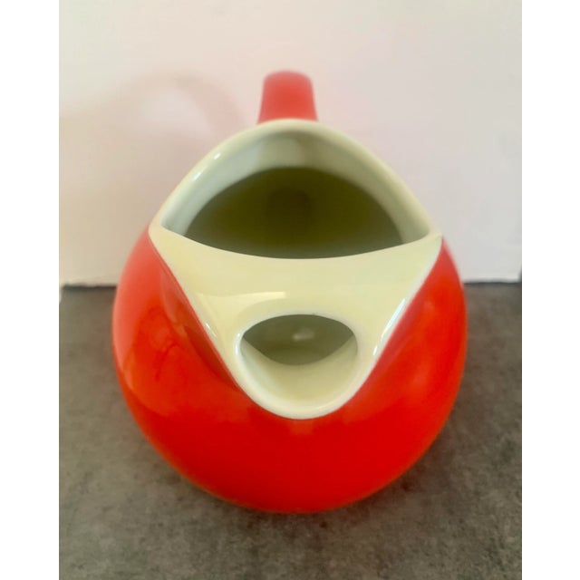 A stunning, vintage Hall USA red ball pitcher no. 633, It has an off white, creamy inside that makes a striking contrast...