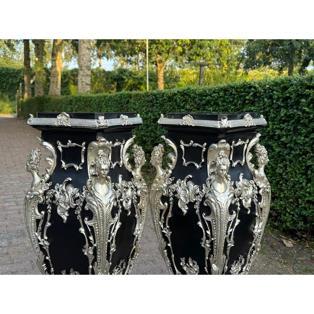 This striking pair of circa 1980 Italian Baroque Revival pedestals combines dramatic sculptural decoration with a...