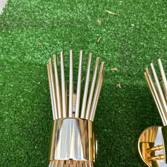 Up for consideration is a beautiful vintage pair of gold metal small tubed starburst style wall sconces. These would look...