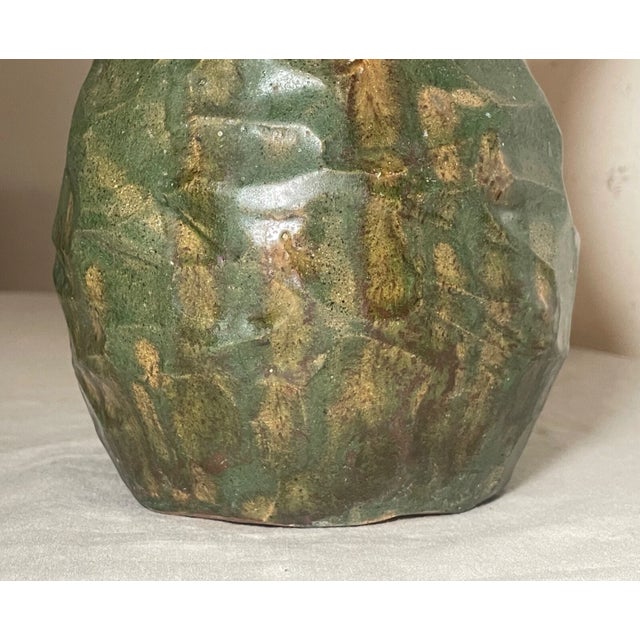 Add a touch of uniqueness to your decor with this beautiful handmade art pottery vase. The green/brown glazed wrinkled...