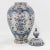 This exquisite vintage tole ginger jar features intricate hand-painted floral and foliate motifs in elegant blue and white...