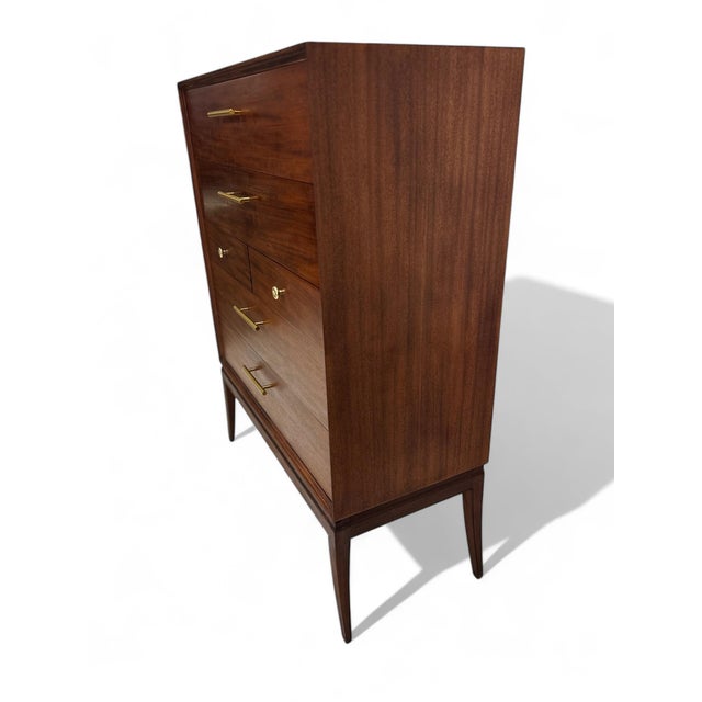 Tommi Parzinger designed this walnut dresser for Charak Modern in 1938 (right before opening his own design studio...