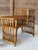 Charming and versatile vintage rattan tiered accent table featuring a warm honey-toned finish, woven rattan shelves, and...