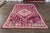 Beautiful hand-knotted vintage tribal wool rug with a purple field, accented with various shades of pink and green, circa...