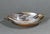 A vintage handcrafted bowl made from natural polished multicolor buffalo horn. The piece has an elegant elongated form...