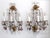 Pair of elegant 1940s gilt metal three-light wall sconces with clear and lavender crystals and beads. Each sconce uses 3...