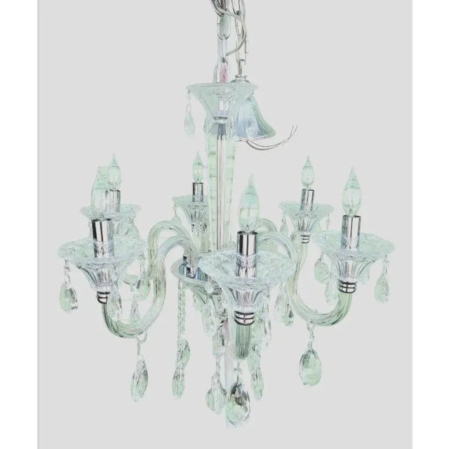 An incredible all Murano glass 6 light crystal chandelier. The chandelier features beautiful cut crystal glass all around...