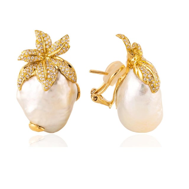 18k Earrings with two free form silver white South Sea pearls measuring 30x22x17mm and 330 round diamonds weighing...