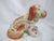 Vintage Staffordshire-style spaniel dog figurine featuring a hand-painted rust-orange and white coat, detailed with a gold...