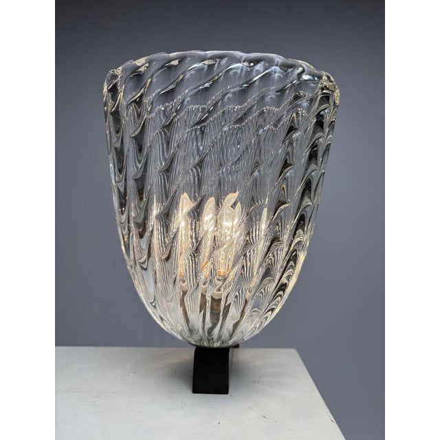 This rare pair of wall lamps represents a masterpiece of 20th-century Venetian craftsmanship, designed by renowned...