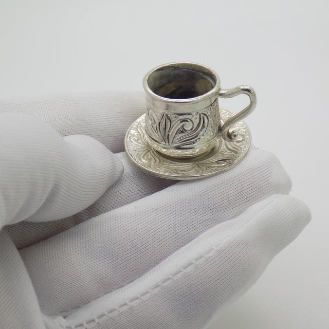 A vintage silver miniature set composed of an espresso cup with matching saucer, handcrafted in silver in Italy between...