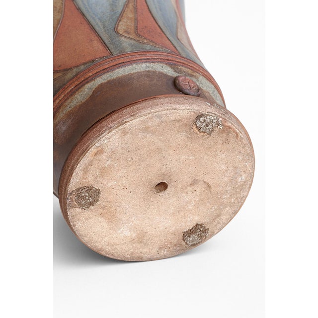 A tall, cylindrical planter by Oregon ceramicist John Connors, marked with his chop stamp. The modernist form is balanced...