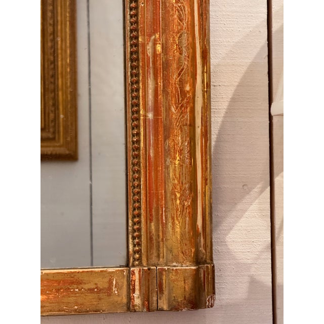 A larger Louis Philippe mirror with the characteristic rounded upper corners and wide molded frame. The surface retains...