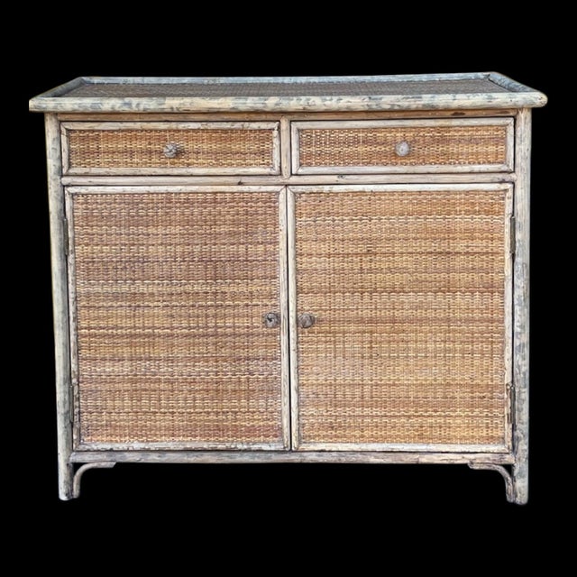 This is a late 20th century Victorian style burnt bamboo and woven grasscloth cabinet . It opens to two shelves. The...