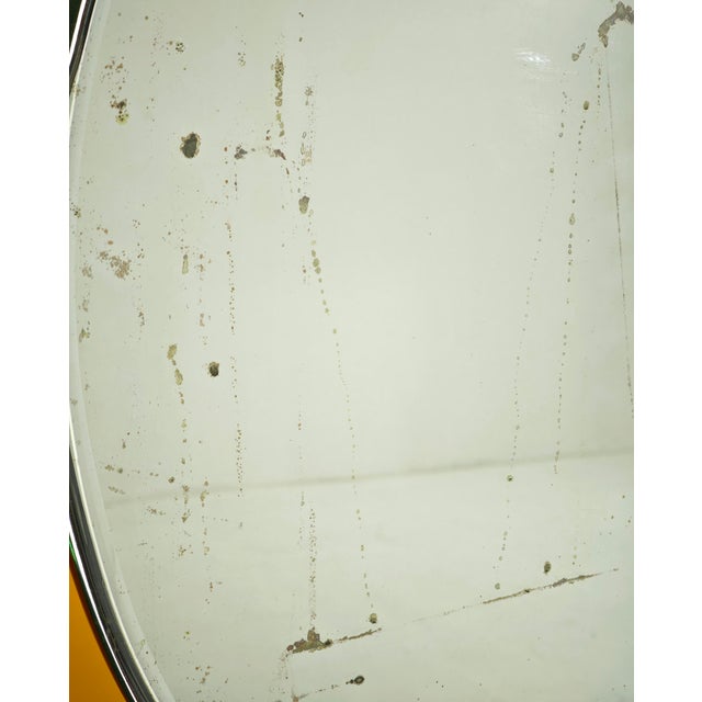 CRISTAL ART (Attr.le) Made in Italy, circa 1950. Oval wall mirror with yellow/amber mirrored glass frame and overlaid...