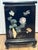 A striking Chinese lacquered cabinet featuring an intricate composition of hardstone and soapstone inlay depicting...