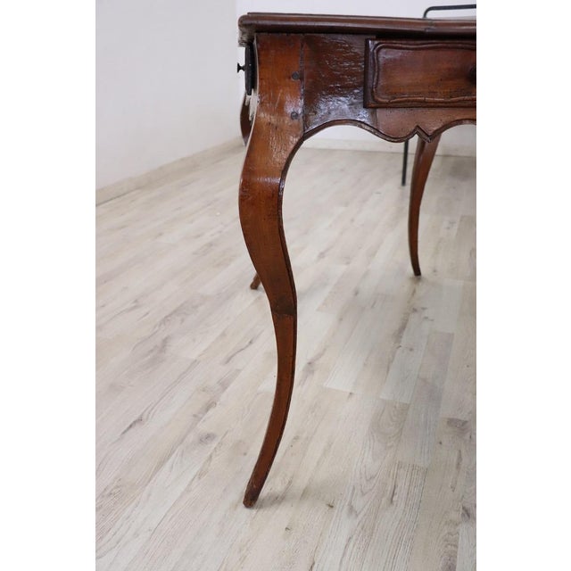 This antique italian louis xv table from the mid-18th century embodies the meticulous craftsmanship and sophisticated...