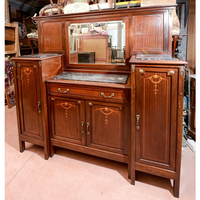Sideboard with black marble top intersections and central mirror veneered in mahogany. Italy art nouveau period...