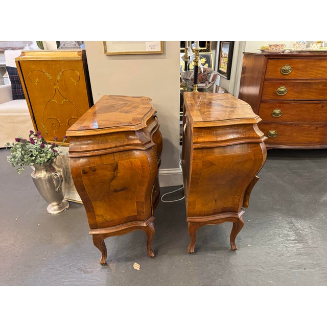 This is an antique Italian chest of drawers. They are made in Italy. It is Burled walnut. It is a bombe style. It has two...