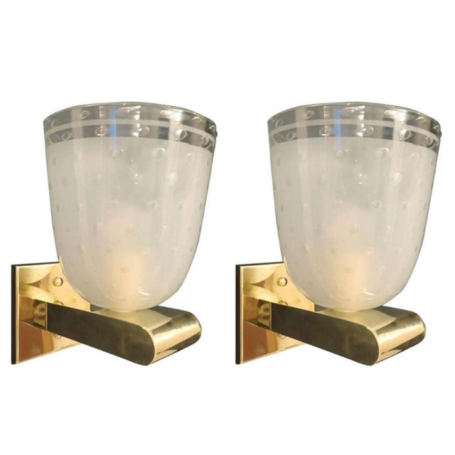 A sophisticated set of six Italian Mid-Century Modern wall sconces, circa 1950's, featuring hand-blown frosted Murano...