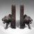 This is a pair of antique carved lion bookends. An Oriental, ebonised ironwood book rest with animal figure interest,...