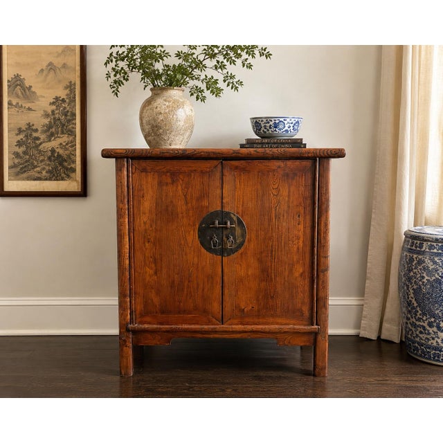 Steeped in quiet elegance, this late Qing Dynasty wedding cabinet was crafted in northern China from solid elmwood, valued...
