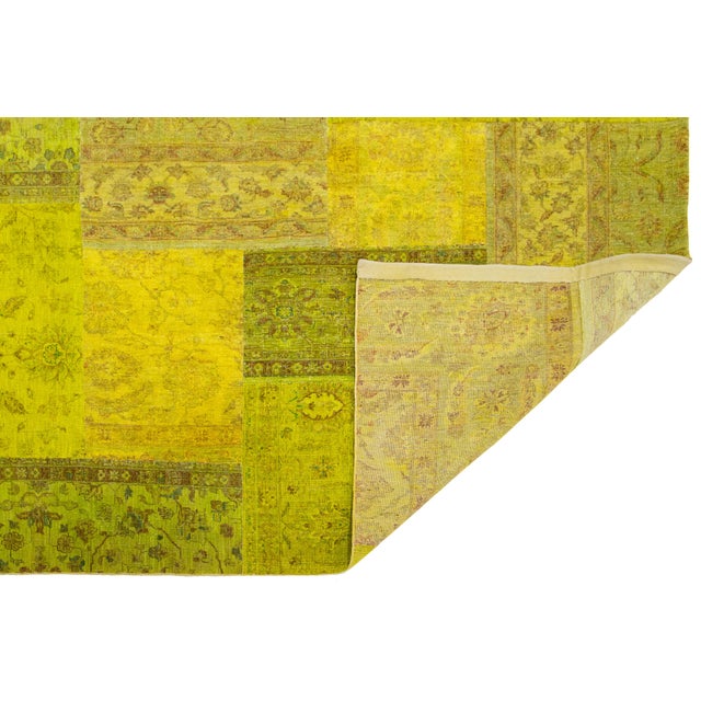 Beautiful handmade patchwork rug featuring a green field. This rug showcases a tribal-inspired frame with multicolored...