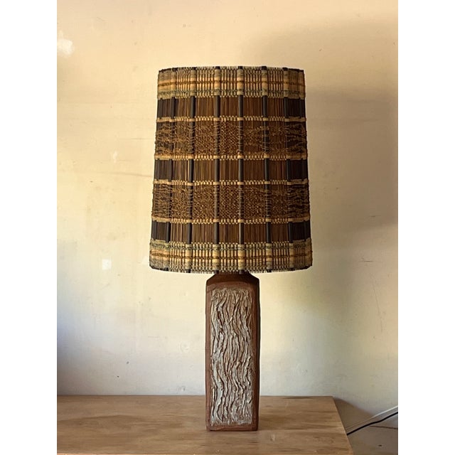 Monumental textured terracotta lamp with impeccable Maria Kipp woven shade. The dimensions listed (18 in. diameter x 41...