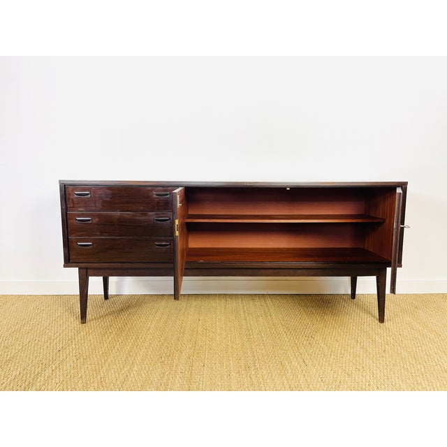 Vintage Scandinavian sideboard from the 1960s featuring two storage doors with a shelf and three drawers. Varnish finish....