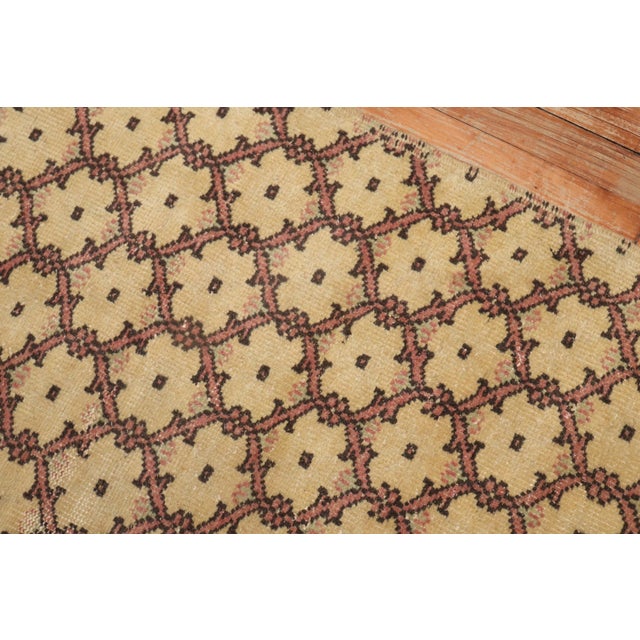 One of a kind decorative Vintage Turkish Konya runner with a repetitive borderless motif in soft pink on a creamy yellow...